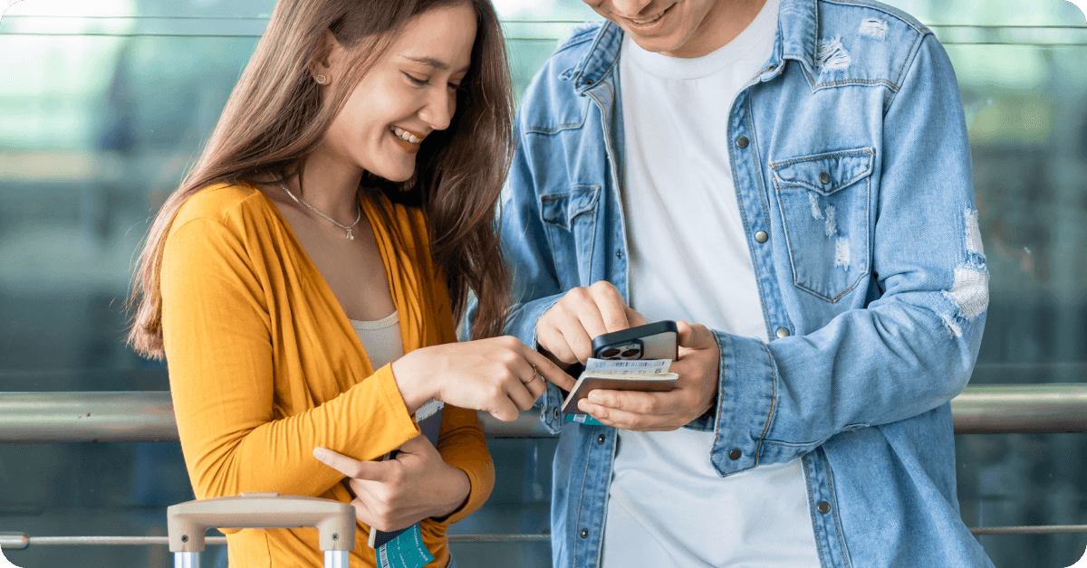 Two travelers looking at a phone.