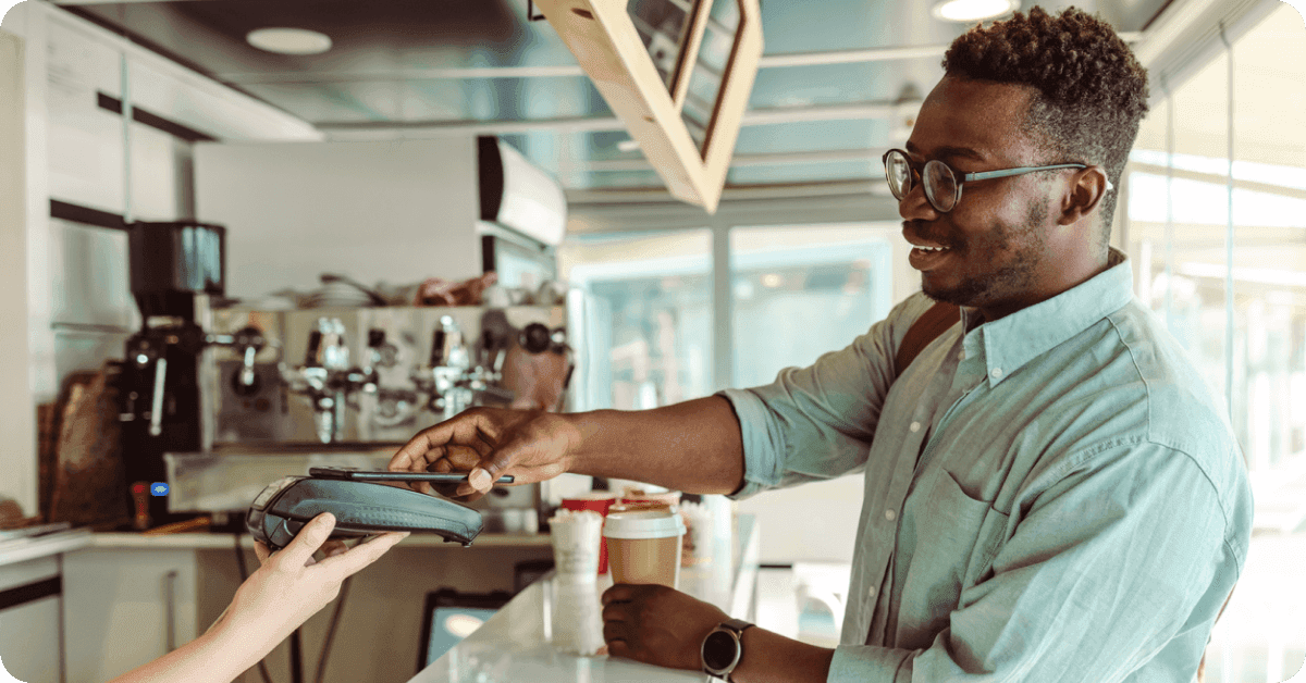 A person paying at a cafe.