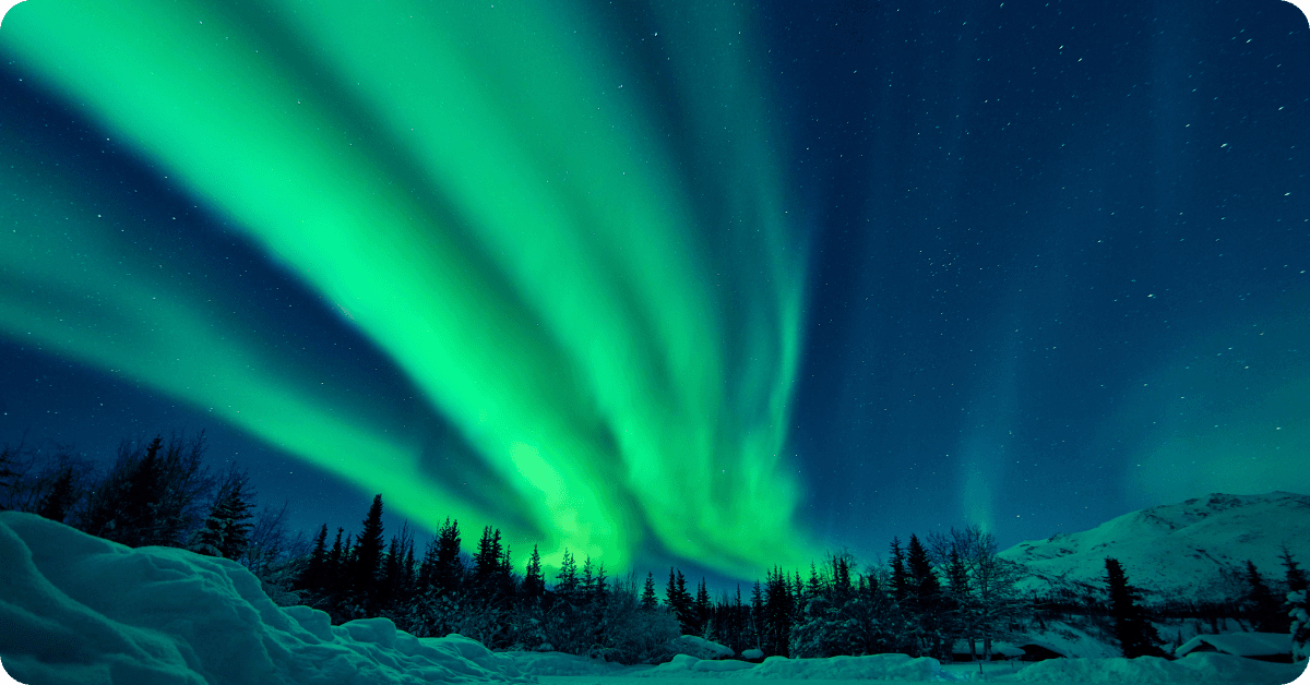 The Northern Lights glow green over Alaska.