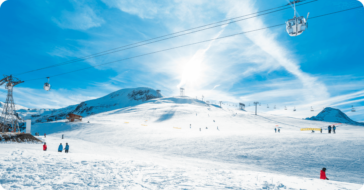 People ski on the slopes of a snowy mountain.