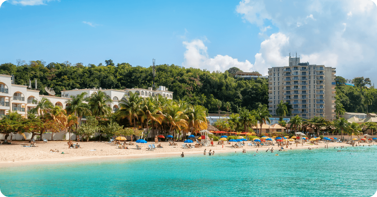 Tourists relax on a sunny beach in Jamaica.