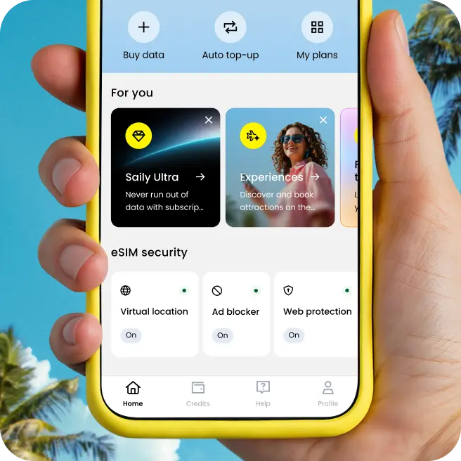 A hand holds a phone with the Saily app open, showing options to manage eSIM plans, mobile data, and security features.