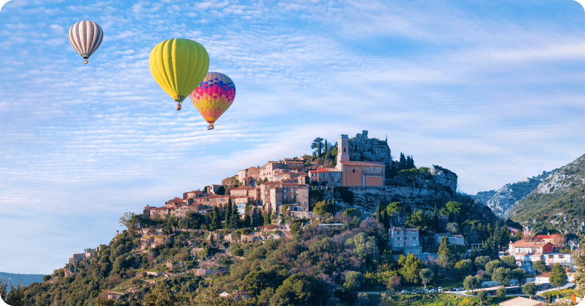 Hot air balloons float over the French countryside.